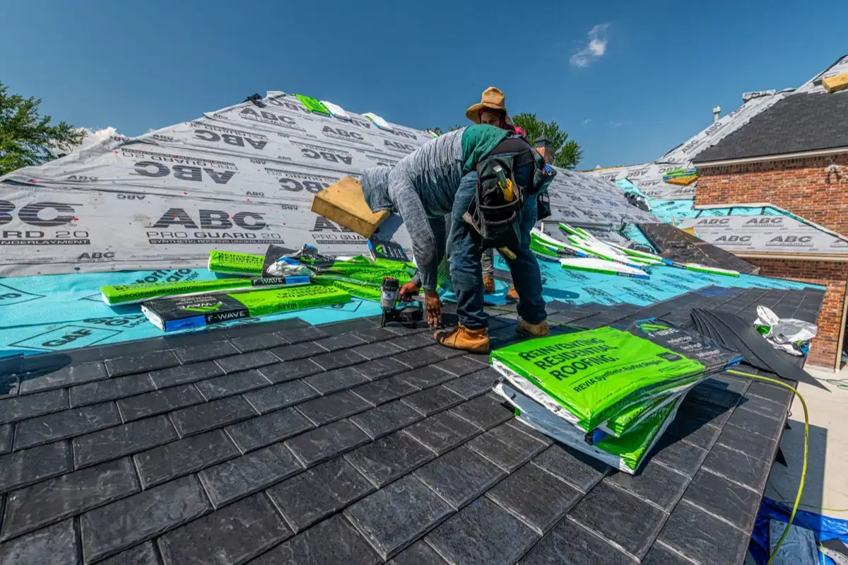 Roofer inspecting decking and underlayment on a residential roof in Nashville, TN